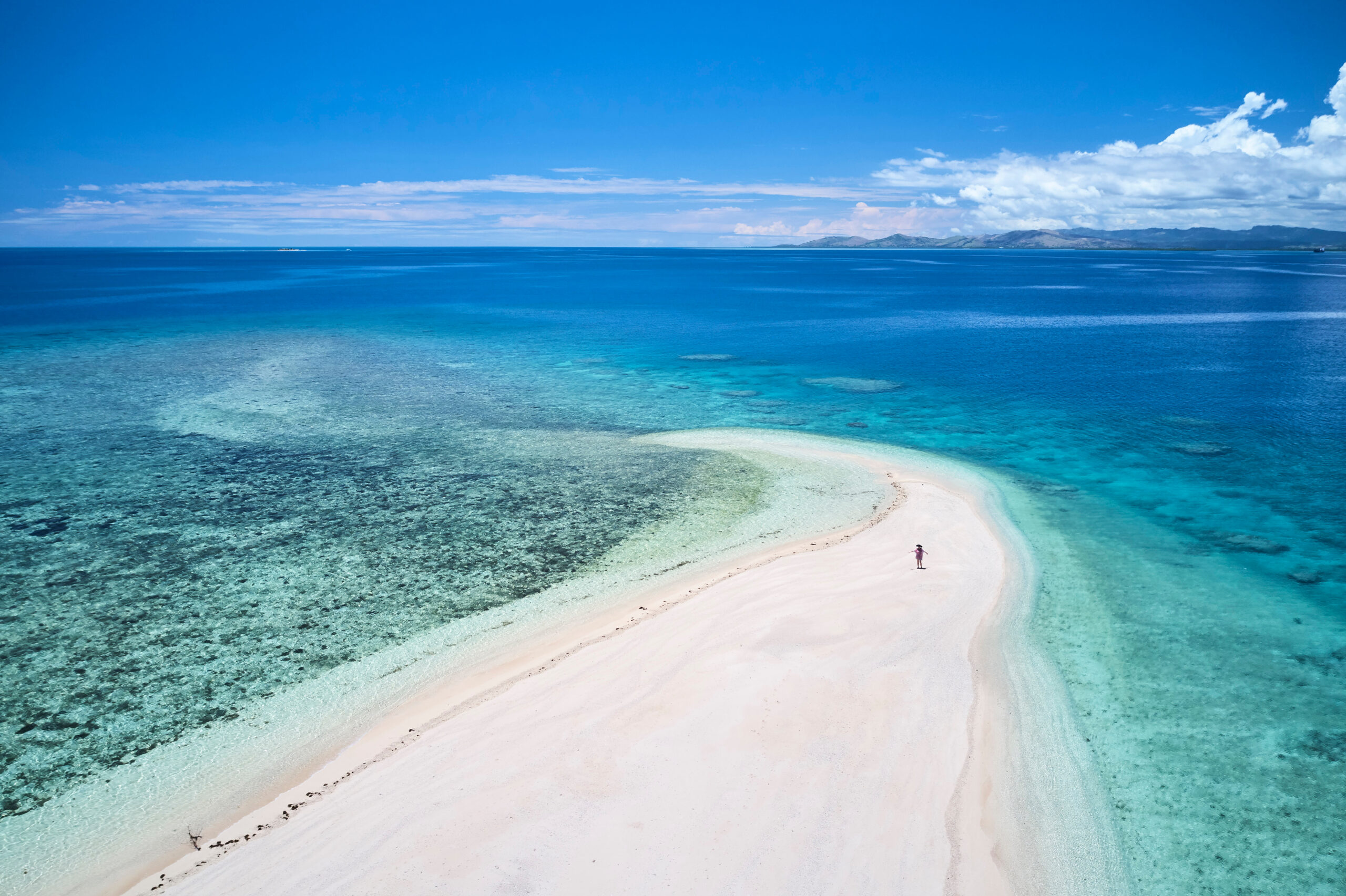 Woman,On,Remote,Island,In,Fiji,Overlooking,Blue,Coral,Reef